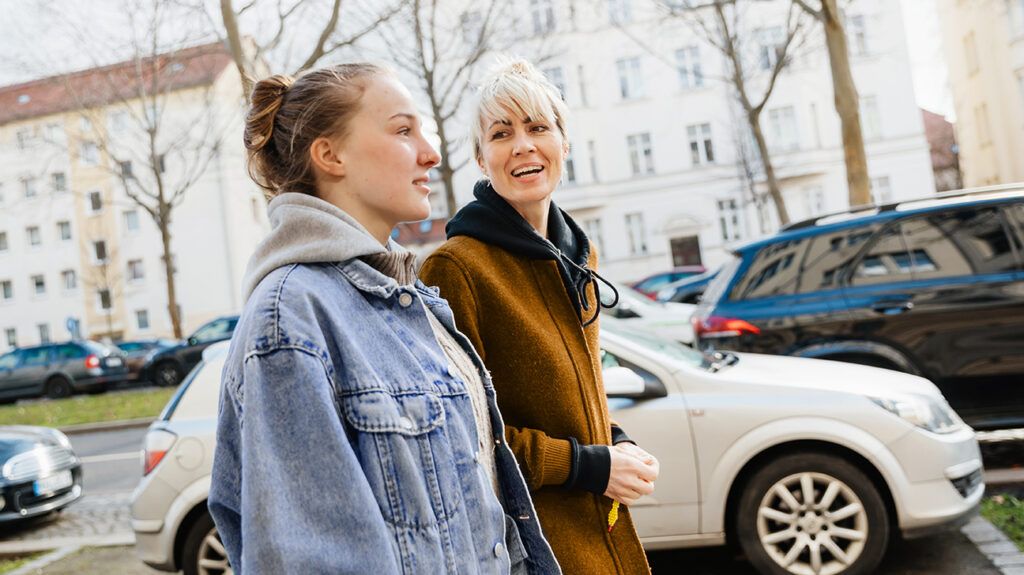 Teenage girl walking with mom